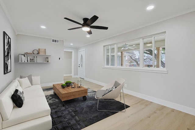 living room featuring hardwood / wood-style flooring, ceiling fan, and ornamental molding