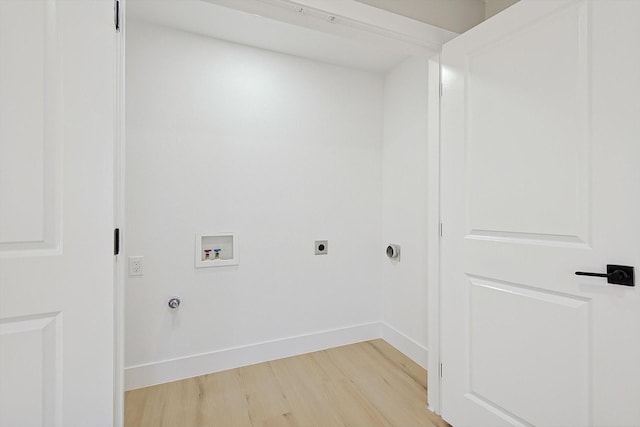 washroom with electric dryer hookup, hookup for a washing machine, light hardwood / wood-style floors, and gas dryer hookup