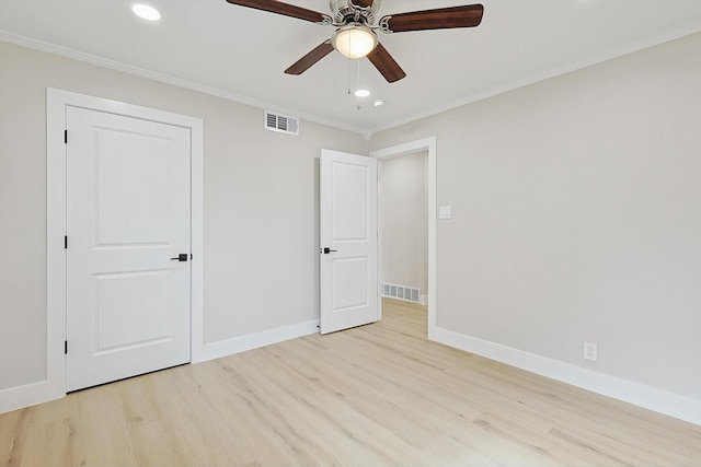 unfurnished bedroom featuring ornamental molding, a closet, ceiling fan, and light wood-type flooring