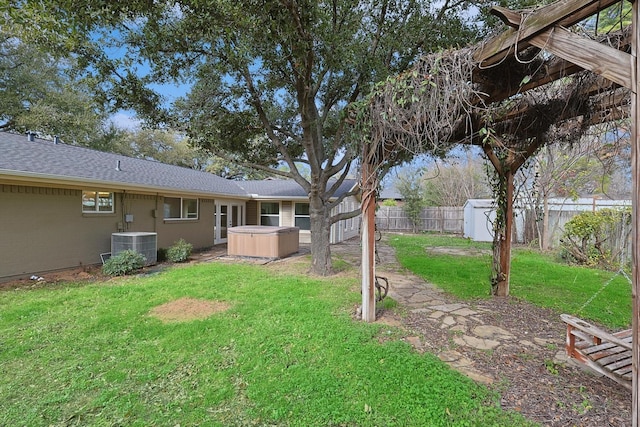 1016 Cavender Dr, Hurst, TX 76053 - view of yard featuring an outdoor structure, a fenced backyard, a shed, a hot tub, and central air condition unit