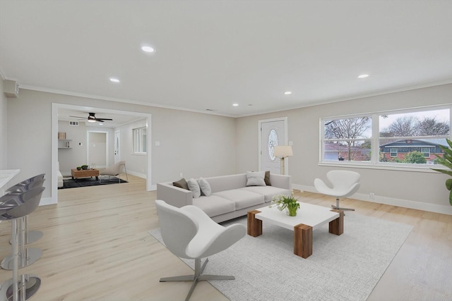 living room featuring crown molding and light wood-type flooring