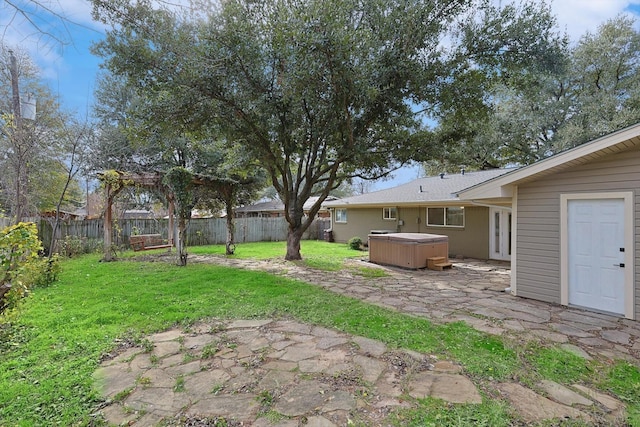 view of yard with a hot tub and a patio