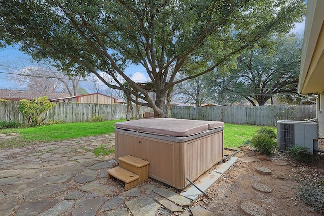 1016 Cavender Dr, Hurst, TX 76053 - exterior space featuring a fenced backyard, a patio, a hot tub, and central AC