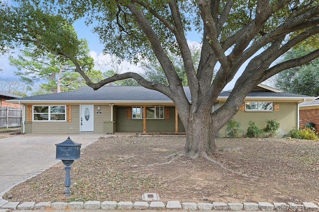 1016 Cavender Dr, Hurst, TX 76053 - view of front of home featuring concrete driveway, brick siding, and fence