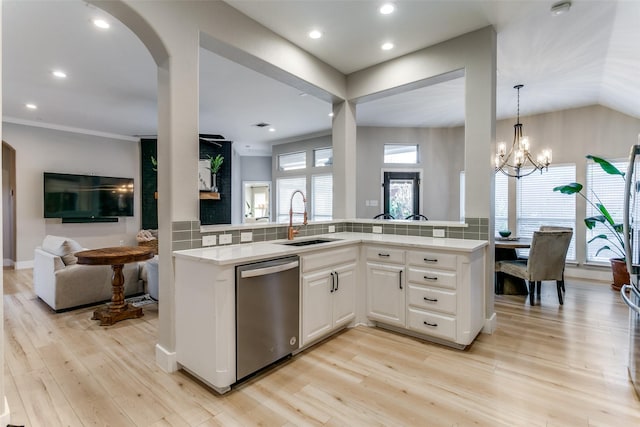 kitchen with white cabinetry, dishwasher, sink, tasteful backsplash, and light hardwood / wood-style floors