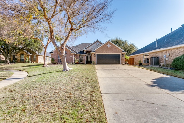 view of front of house featuring central AC unit, a garage, and a front lawn