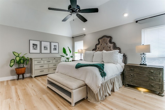 bedroom featuring ceiling fan, light hardwood / wood-style floors, and lofted ceiling