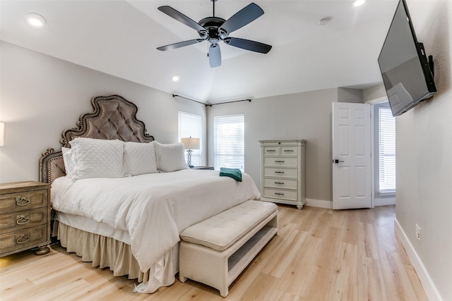 bedroom featuring ceiling fan, light hardwood / wood-style floors, and vaulted ceiling