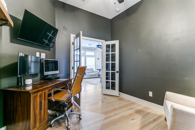 home office with hardwood / wood-style floors and french doors