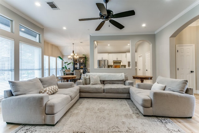 living room with ceiling fan with notable chandelier, crown molding, and light hardwood / wood-style flooring