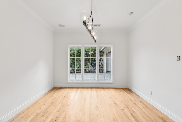 interior space with a chandelier, ornamental molding, and light wood-type flooring