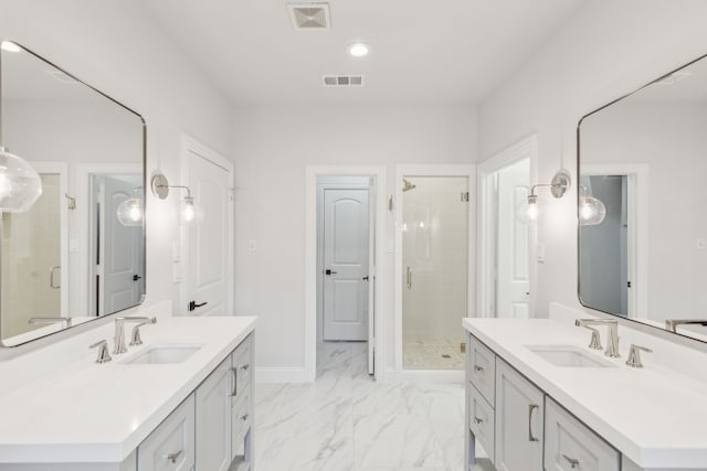 bathroom featuring a shower with door and vanity