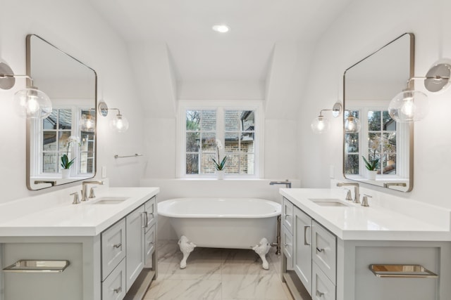 bathroom with a tub and vanity