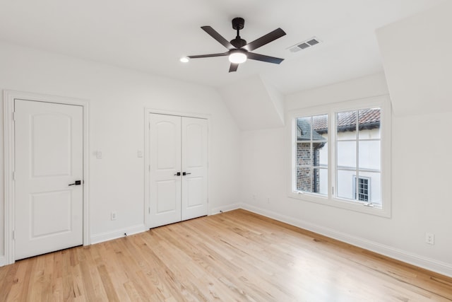 unfurnished bedroom with vaulted ceiling, ceiling fan, and light hardwood / wood-style floors