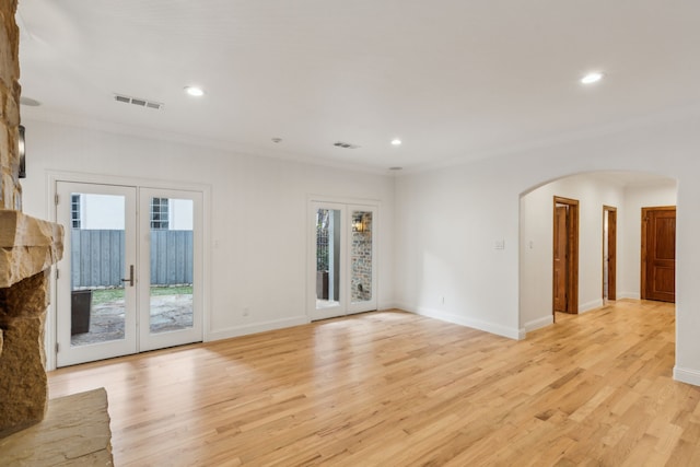 spare room with french doors, ornamental molding, and light hardwood / wood-style floors