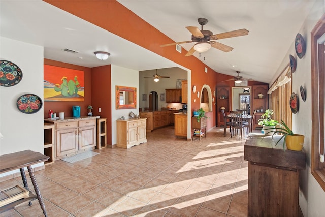 interior space with light tile patterned floors and vaulted ceiling