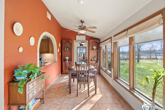 dining space featuring light tile patterned floors, ceiling fan, lofted ceiling, and sink