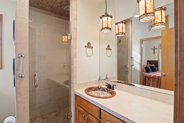 bathroom with vanity and a shower with door