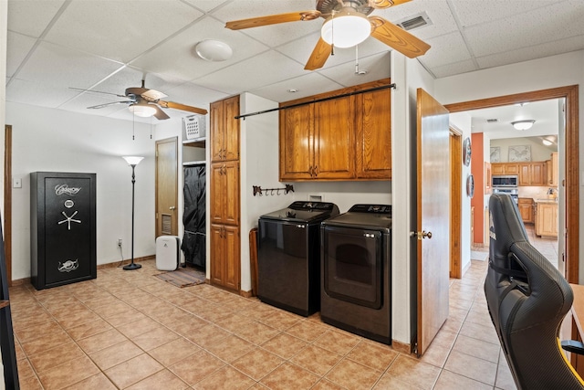 washroom featuring washer and dryer, light tile patterned flooring, cabinets, and ceiling fan