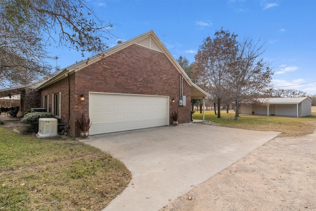 view of side of home featuring a lawn and a garage