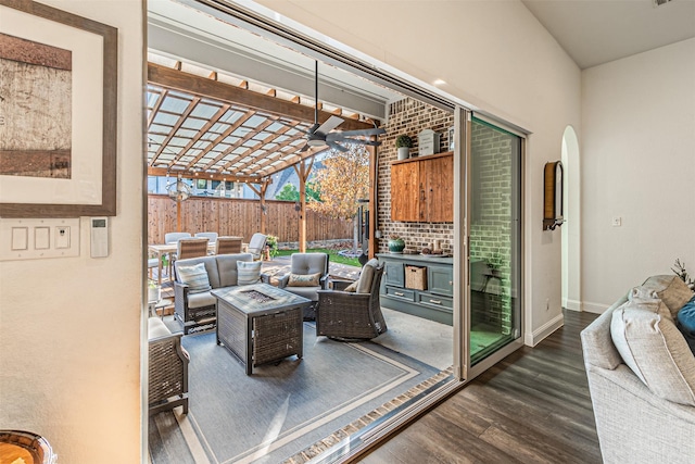 interior space with a pergola and an outdoor living space with a fire pit