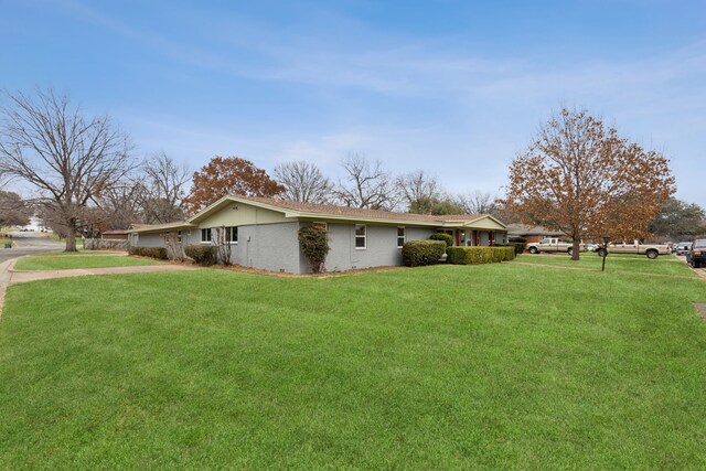 view of property exterior with a yard