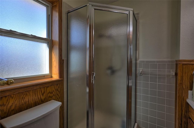 bathroom featuring toilet and walk in shower