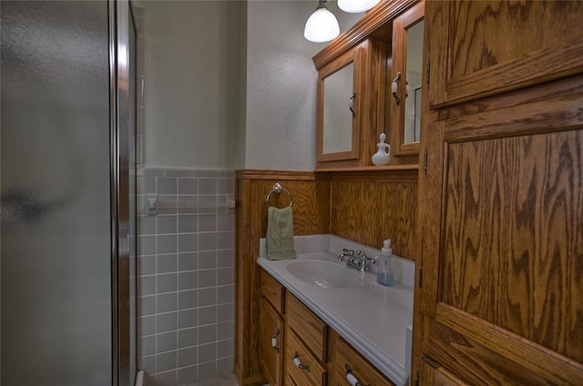 bathroom with vanity and a shower with shower door