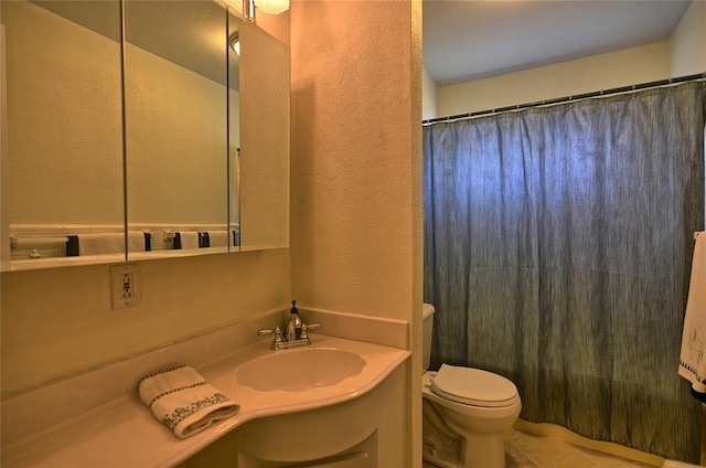 bathroom featuring tile patterned flooring, vanity, and toilet