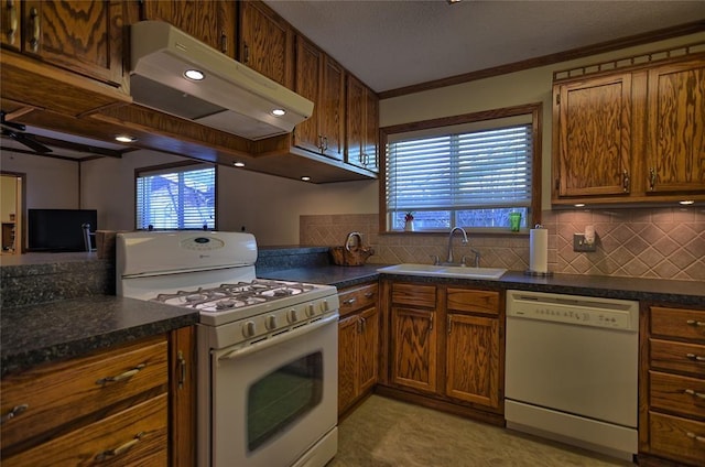 kitchen with ceiling fan, sink, backsplash, crown molding, and white appliances