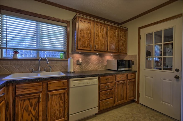 kitchen featuring white dishwasher, tasteful backsplash, ornamental molding, and sink