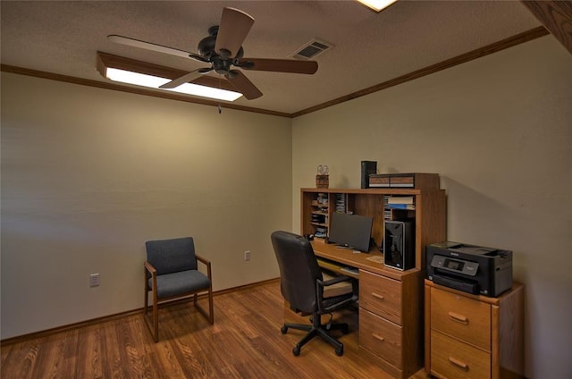 unfurnished office with ceiling fan, crown molding, wood-type flooring, and a textured ceiling