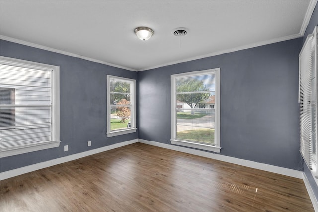 empty room featuring ornamental molding and dark wood-type flooring