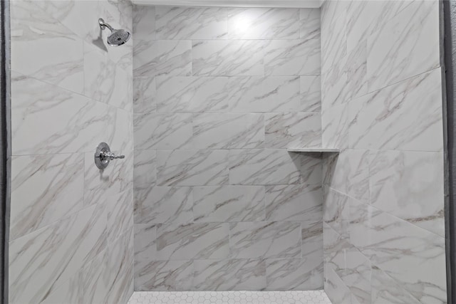 bathroom with a tile shower