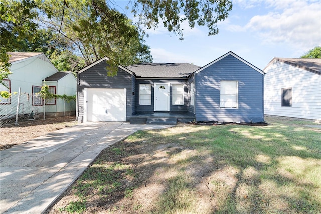 ranch-style home featuring a garage and a front lawn