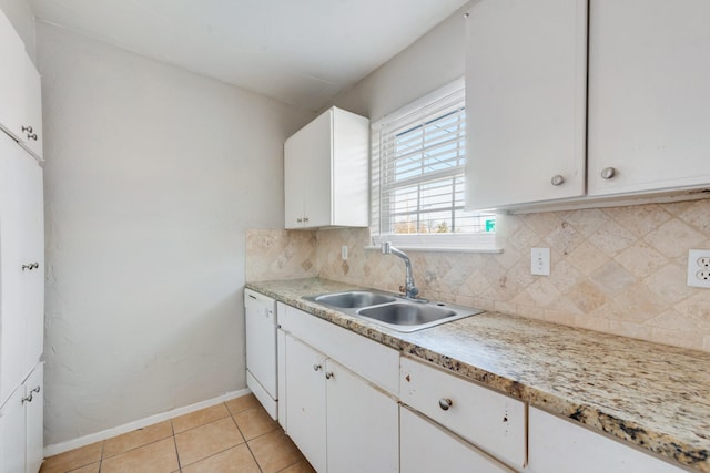 kitchen with white cabinets, sink, backsplash, light tile patterned flooring, and white dishwasher