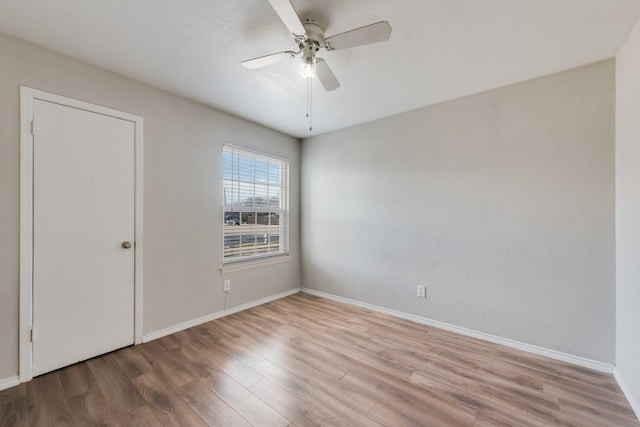 empty room featuring ceiling fan and light wood-type flooring