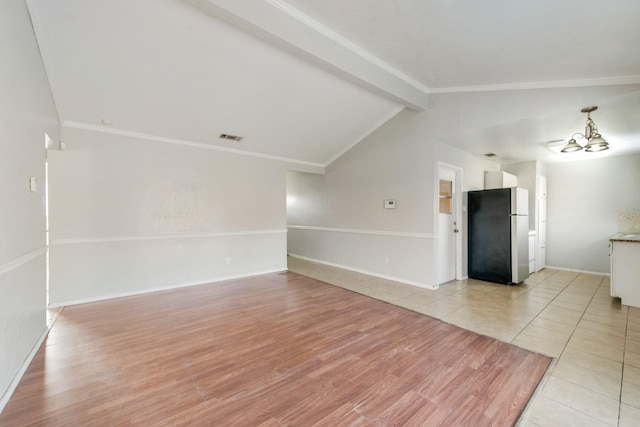 unfurnished living room with light wood-type flooring, lofted ceiling with beams, an inviting chandelier, and ornamental molding