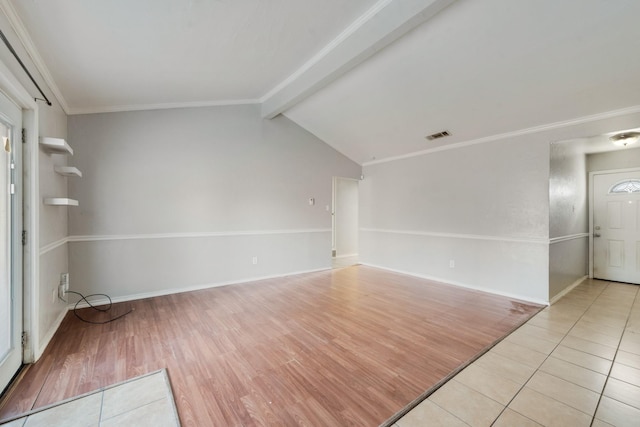 tiled spare room featuring crown molding and lofted ceiling with beams