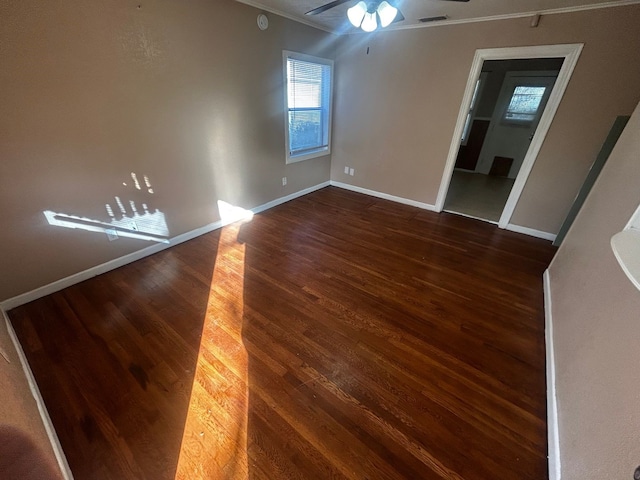 spare room with dark hardwood / wood-style floors, ceiling fan, and ornamental molding