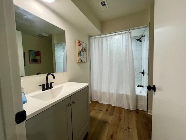 bathroom with vanity, wood-type flooring, and shower / tub combo