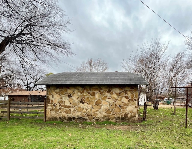 view of outbuilding with a yard