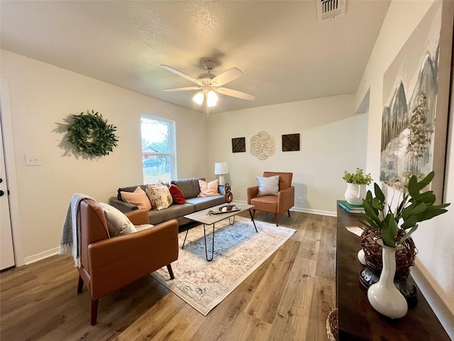 living room with ceiling fan and wood-type flooring