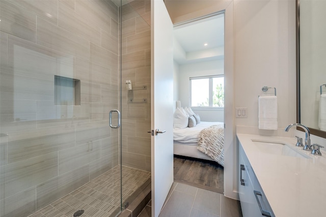 bathroom with tile patterned floors, vanity, and walk in shower