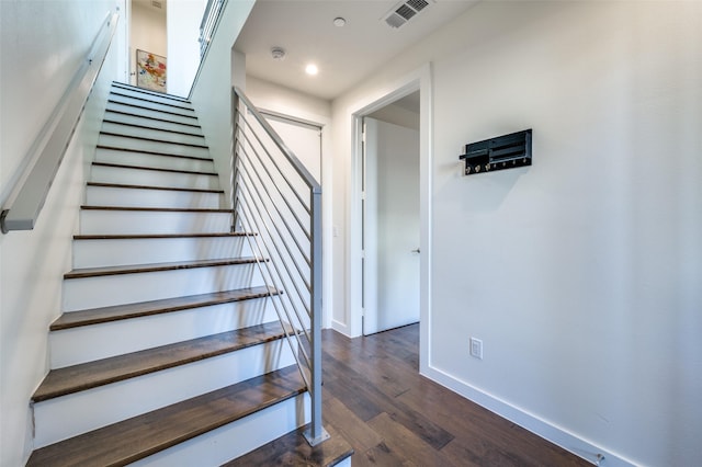 staircase with hardwood / wood-style floors