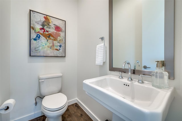 bathroom featuring hardwood / wood-style floors, toilet, and sink