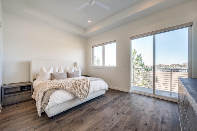 bedroom with access to outside, a raised ceiling, ceiling fan, and dark wood-type flooring