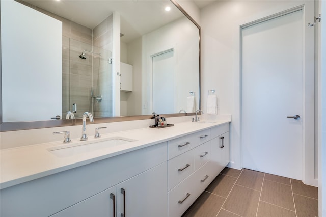 bathroom with vanity and a shower with door