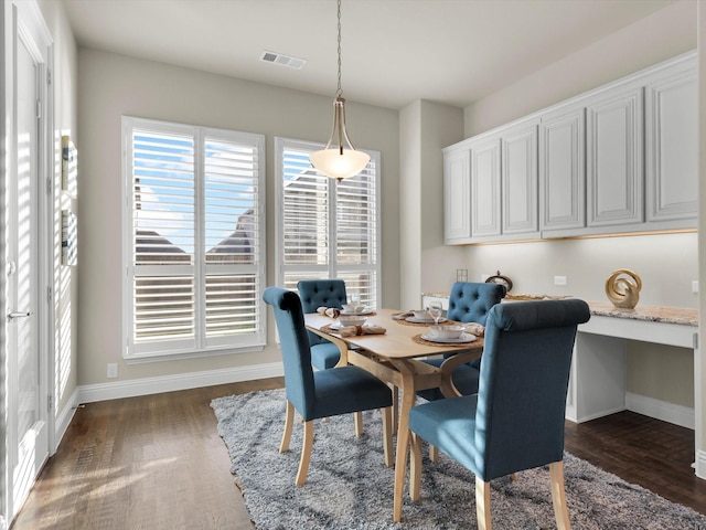 dining space with dark wood-type flooring