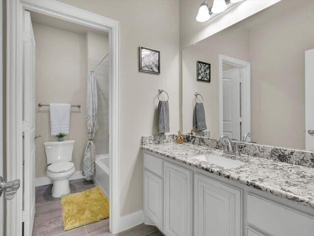 full bathroom with vanity, shower / bath combination with curtain, and toilet